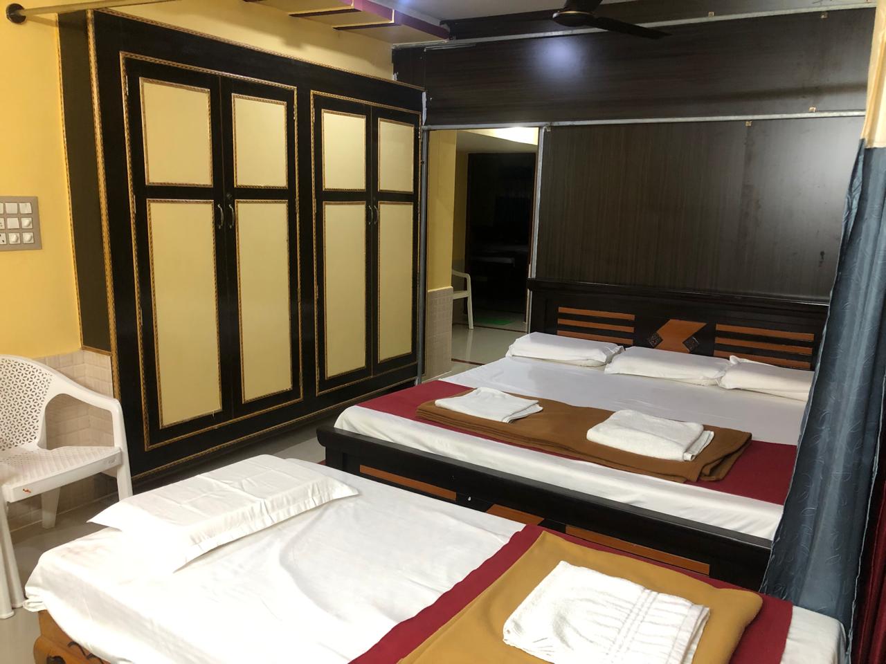 Two-bedroom house interior with beds and wardrobe